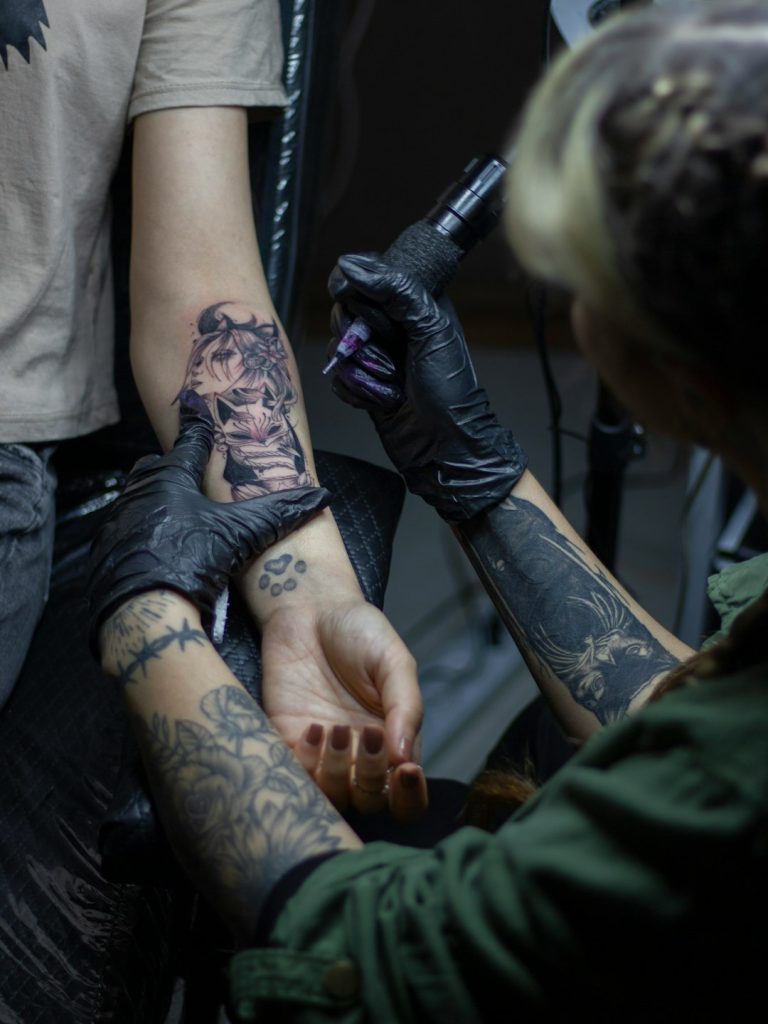 Tattoo artist tattooing.